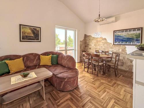 a living room with a couch and a table at Apartment Ananina by Interhome in Rovanjska