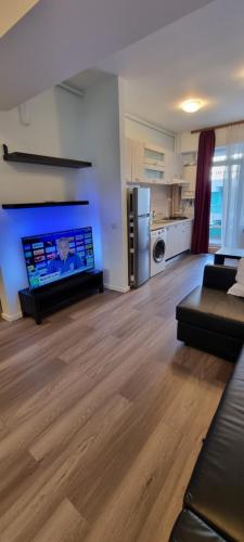 a large living room with a couch and a kitchen at Monaco Summerland Rentals in Mamaia