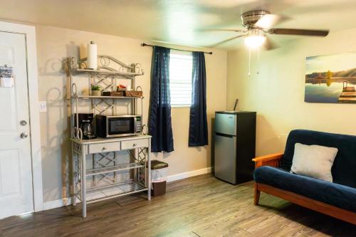 a living room with a refrigerator and a couch at Near Lake Texoma Quad-plex - 28 in Mead
