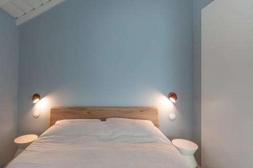a bedroom with a bed with two lights on it at Barranquinho in Santiago do Cacém