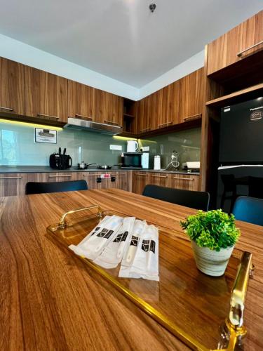 a wooden table with white napkins on top of it at Sunway Onsen Ipoh by EUcation Home in Tambun