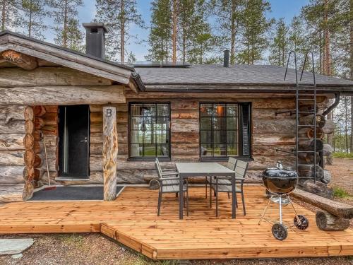 a cabin with a table and chairs on a deck at Holiday Home Harjula by Interhome in Nissi
