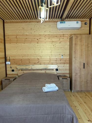 a bedroom with a bed with two towels on it at Armenian Corner in Pʼarakʼar