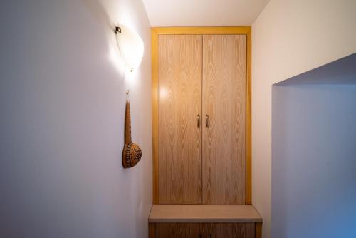 a room with a wooden door and a cabinet at Casa Piedra, Hidden Gem, Jacuzzi, BBQ, Patio in Monagroulli in Monagrulli