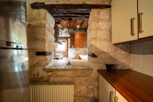 a kitchen with stone walls and a counter top at Casa Piedra, Hidden Gem, Jacuzzi, BBQ, Patio in Monagroulli in Monagrulli