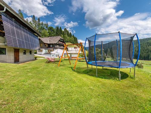 a playground with a trampoline in a yard at Apartment Herzele by Interhome in Arriach