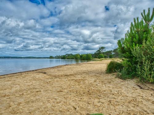 a sandy beach next to a body of water at Apartment Les Océanides-14 by Interhome in Lacanau-Océan