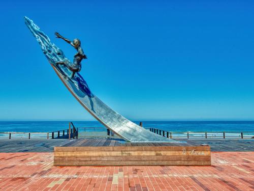 a statue of a woman on a staircase near the beach at Apartment Les Océanides-14 by Interhome in Lacanau-Océan