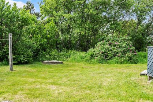 a park with a bench in the grass at 616-Hvide-Sande-Sigfred-Jensens-Vej-9 in Bjerregård