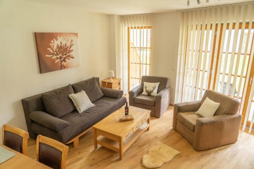 a living room with a couch and two chairs and a table at Andrea 3 by SMR Luxury Apartments inc Spa and near Gondola in Rauris