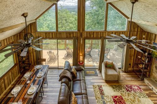 a living room with a couch and some windows at Heavenly Gaze in Pigeon Forge