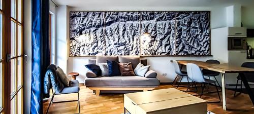 a living room with a couch and a table at Andrea 7 by SMR Rauris Apartments - inc Spa and near Gondola in Rauris