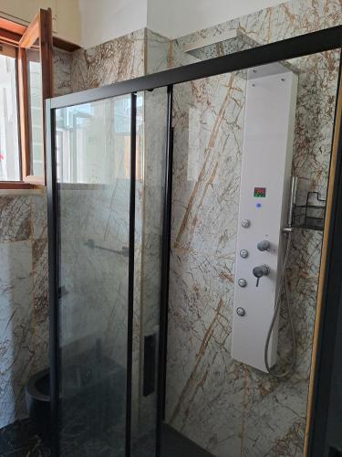 a shower with a glass door in a bathroom at The bathers' Home in Nettuno
