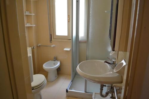 a bathroom with a sink and a toilet at L'Antico Borgo in Lesa