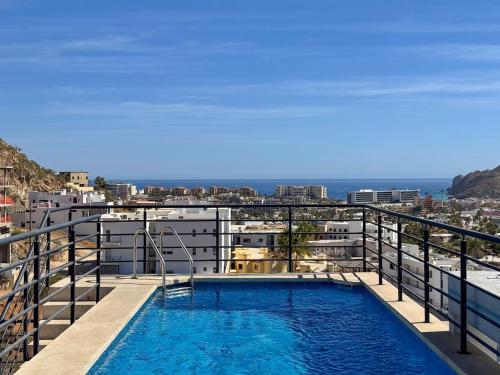 a swimming pool on the balcony of a building at 2 BR Wake up to unique views from your balcony in Cabo San Lucas