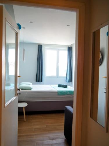 a small bedroom with a bed and a window at Athens Pearl in Athens