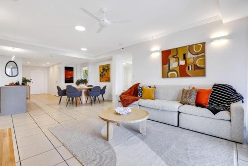 a living room with a couch and a table at Skyview Luxe at Marquis in Cairns
