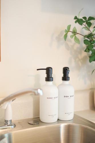 two bottles of soap sitting on top of a sink at Wilderness West Resort Cabin 4 in Colville