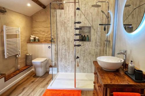 a bathroom with a shower and a sink at Just Opened. Romantic Clifftop Retreat in Portloe