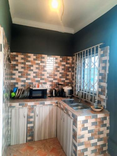 a kitchen with a sink and a counter top at StayCommidad in Tamale