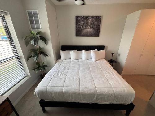 a bedroom with a large bed with white sheets and pillows at Charcoal Loft in Des Moines