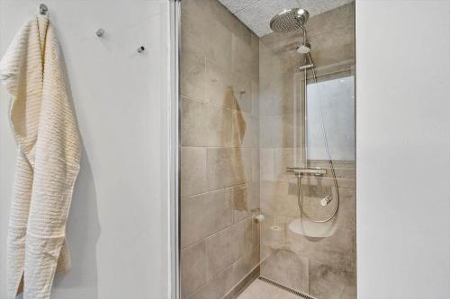 a bathroom with a shower with a glass door at 9953-Hvide-Sande-Langsand-212 in Hvide Sande