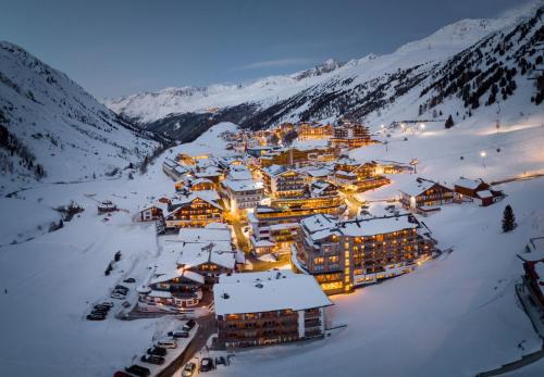 a group of buildings in the snow at night at Residence by Gourmet & Wine Hotel Austria in Obergurgl