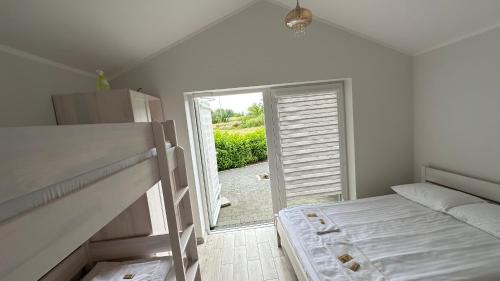 a bedroom with a bed and a door to a yard at Noclegi Pod Orłami in Lubaczów