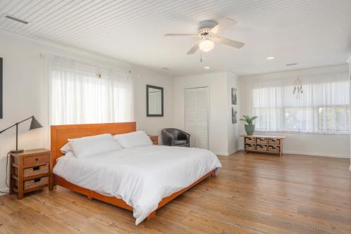 a bedroom with a bed and a ceiling fan at Pescadora by Rather Be Properties in Frisco