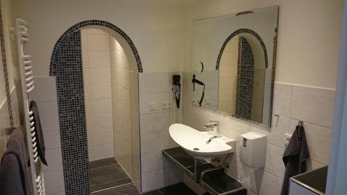 a bathroom with a sink and two mirrors at Haus Hohenzollern & Haus 'Ambiente in Bad Bertrich