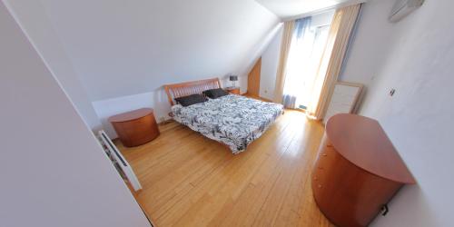 a bedroom with a bed and a wooden floor at Spacious Penthouse Sofia in Sofia