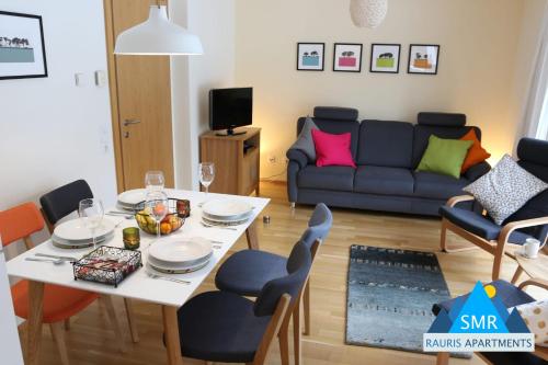 a living room with a table and a couch at Christina 1 by SMR Rauris Apartments - inc Spa and near Gondola in Rauris