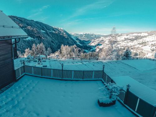 a snow covered balcony with a view of a mountain at Apartment Grimming by Interhome in Donnersbach