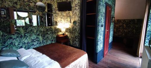 a bedroom with a bed in a room with plants on the walls at Willa Wydra in Krościenko