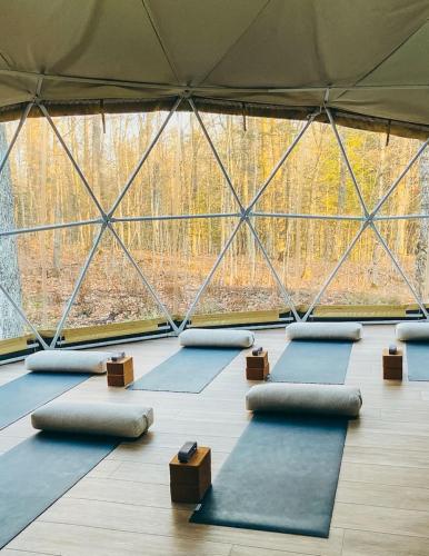 a group of yoga mats in a room with a large window at Tranquil Waters at Dimensions - Cabin Two in Algonquin Highlands