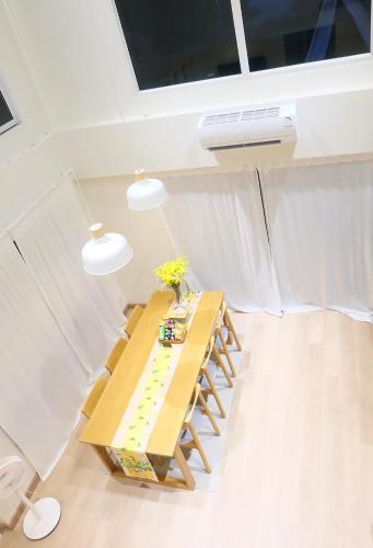 a room with a wooden table with flowers on it at Villa at Waterville Khaoyai in Ban Khanong Phra Klang (1)