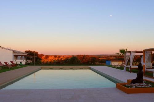 a view of a pool from the backyard of a house at Herdade da Yucca - Retreat & Spa in Terena