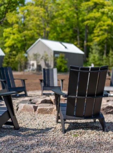 a group of chairs sitting on top of a field at Sauna Trail Hideaway at Dimensions - Cabin Seven in Algonquin Highlands
