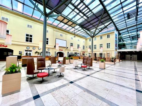 a lobby with chairs and tables in a building at JUFA Hotel Wien City in Vienna