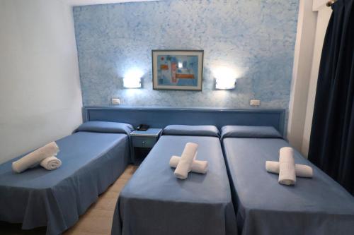 a room with two beds with crosses on them at Santa Monica Playa in Salou