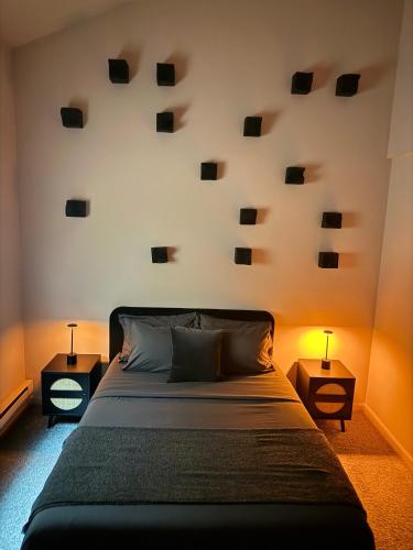 a bedroom with a bed and two nightstand tables at Poconos Modern Chalet-Hot Tub-Home Theater-Lake in East Stroudsburg