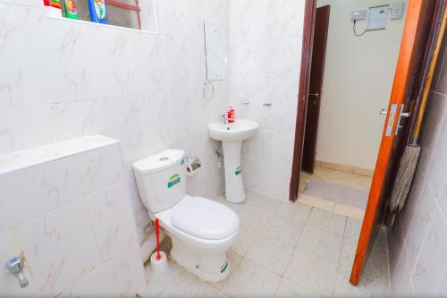 a bathroom with a toilet and a sink at lexy homes in Ruiru