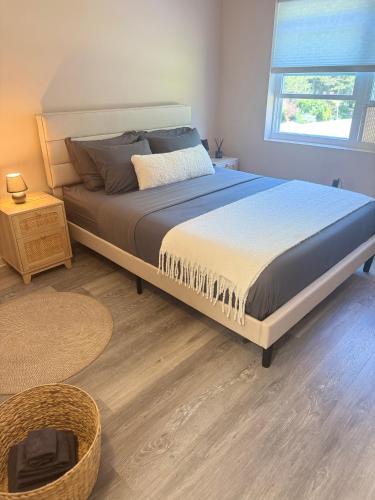 a large bed in a bedroom with a window at Poconos Modern Chalet-Hot Tub-Home Theater-Lake in East Stroudsburg