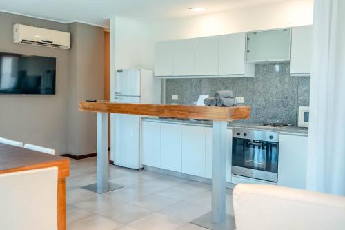 a kitchen with white cabinets and a counter top at Rincón del Duende Resort y Spa de Mar in Mar de las Pampas