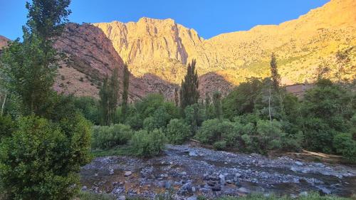 a river in a canyon with a mountain in the background at Gîte Jamal taghia in Taghia