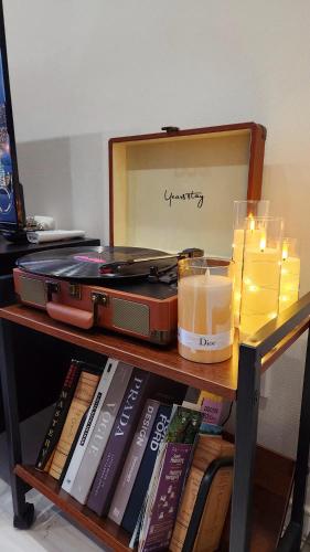 a table with a suitcase and candles and books at Casa Bella in Seoul