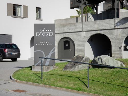 a sign in front of a building with two large rocks at Apartment La Siala Apt-7 by Interhome in Falera