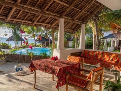 a living room with a couch and a table at Villa Juliana in Jambiani
