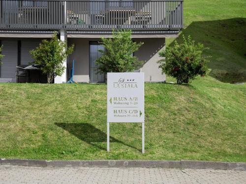 a sign in the grass in front of a house at Apartment La Siala Apt-30 by Interhome in Falera