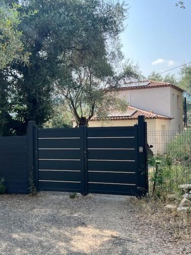 a blue gate in front of a house at Évasion Tranquille à 20 min de Nice in Contes